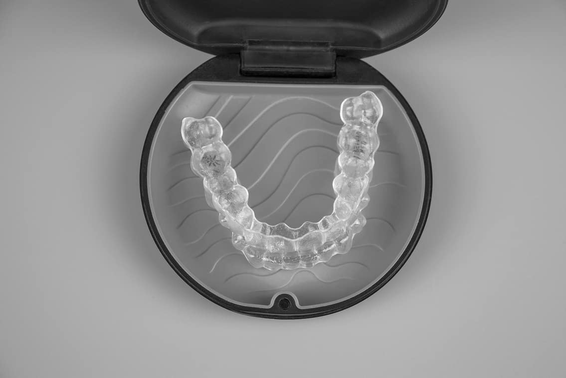 Invisalign transparent braces in a plastic case. Orthodontic invisible retainers and aligners